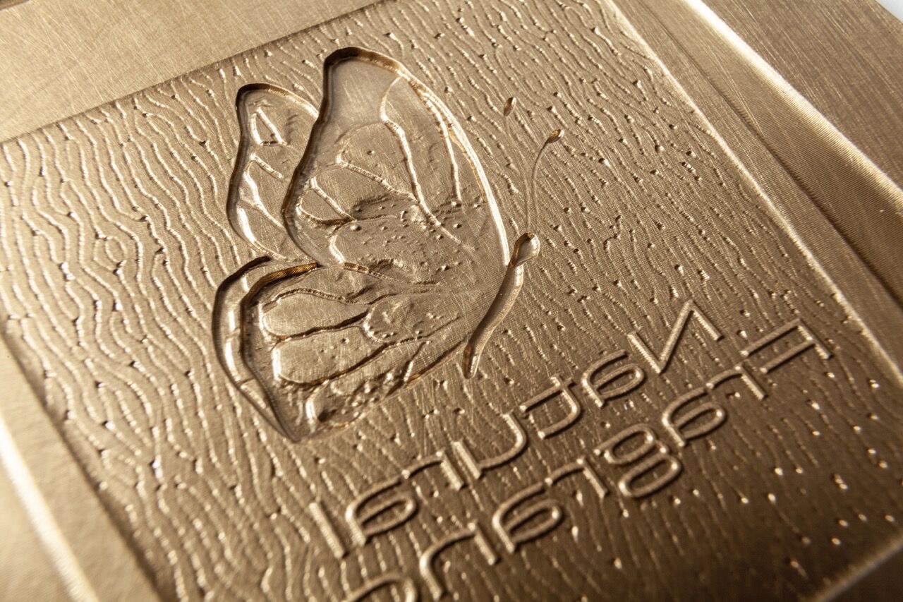 Embossing Tools for Haptic Surface Finishes & 3D Effects Hot-stamping die with butterfly & fine lettering